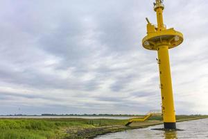 nordenham niedersachsen deutschland 2010 gelber leuchtturm deich deich watt wellen landschaft küste nordenham deutschland. foto