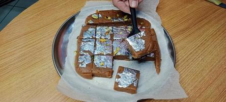 keks-süßes rezept, indische süße lebensmittel aus keks, keks mithai, milch-barfi auf holzhintergrund foto