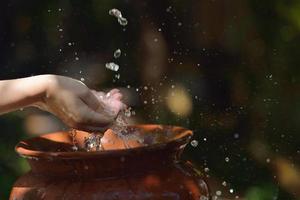 frisches Wasser auf die Hände der Frau spritzen foto