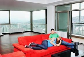 Glückliches Paar entspannen auf rotem Sofa foto
