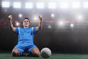 Fußballspieler vor einem großen modernen Stadion mit Fackeln und Lichtern foto