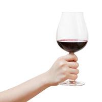 Hand erhebt sich großes Glas mit Rotwein foto