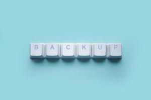 Word-Backup geschrieben auf Tasten der Computertastatur isoliert auf einem Türkis foto