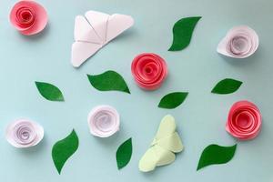 Origami-Papierhintergrund mit Schmetterlingen, Blumen und Blättern. Origami-Zusammensetzung. Papierhandwerk foto