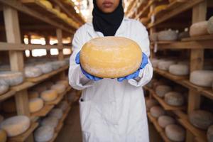afrikanische schwarze muslimische geschäftsfrau in einer lokalen käseproduktionsfirma foto