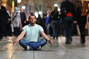 junger Mann meditiert Yoga im Lotussitz foto