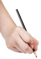 Hand schreibt mit schwarzem Bleistift, isoliert auf weiss foto