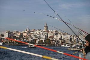 Menschen, die über die Galata-Brücke fischen foto