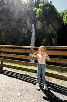 Mädchen gegen Wasserfall in Liechtensteinklamm oder Liechtensteinklamm, Österreich. foto