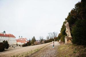 Babymädchen mit Blick auf Denkmal auf Schloss Valtice, Tschechische Republik. foto