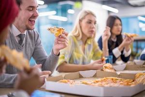 multiethnisches geschäftsteam, das pizza isst foto