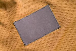 Wäschepflege-Kleidungslabel-Patch auf Polyestergewebe-Jersey-Sportstruktur foto