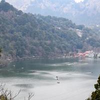 volle ansicht des naini-sees während der abendzeit nahe der einkaufsstraße in nainital, uttarakhand, indien, schöne ansicht des nainital-sees mit bergen und blauem himmel foto