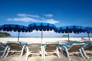Stühle und Sonnenschirm an einem wunderschönen tropischen Strand foto