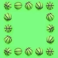 Der Rahmen vieler kleiner grüner Bälle für das Basketballsportspiel liegt auf Texturhintergrund foto