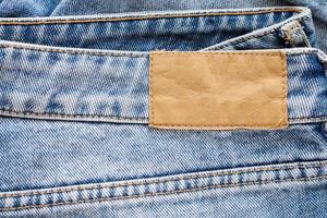 blauer Denim-Jeans-Leder-Label-Textur-Hintergrund foto