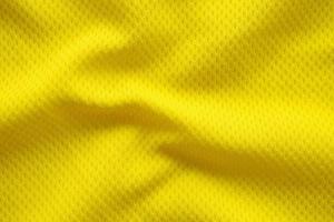 gelbe farbe fußball trikot kleidung stoff textur sportbekleidung hintergrund, nahaufnahme foto