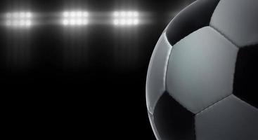 Fußball auf schwarzem Hintergrund unter Stadionbeleuchtung foto
