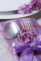 Tischdekoration in violetten Farben, Dekoration Blumen Flieder.