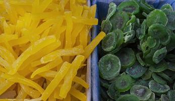 Trockenfrüchte Melone Kiwi, Haufen kandierter Scheiben in Kisten auf dem Markt foto