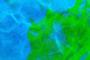gemischte blau-grüne flache Plastilin-Textur mit deutlichen Fingerabdrücken. kleine Staubpartikel auf der Oberfläche. foto