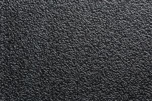flache, schwarze, robuste Kunststoff- oder Gummioberfläche mit dekorativer Noppenoberfläche foto