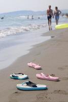Paar Sandalen am Strand