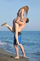 glückliches junges Paar hat romantische Zeit am Strand foto