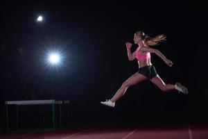 sportliche Frau, die auf der Strecke läuft foto