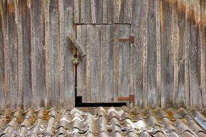 geschlossene Holztür zu einem Dachboden im rustikalen Holzhaus foto