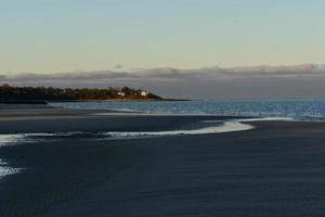 hübscher Strand von Orleans bei Ebbe während des Sonnenuntergangs foto