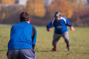 American-Football-Team mit Trainer in Aktion foto