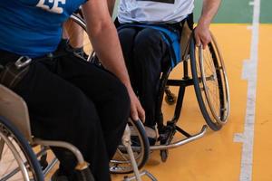 Nahaufnahme von Rollstühlen und behinderten Kriegsveteranen, die auf dem Platz Basketball spielen foto