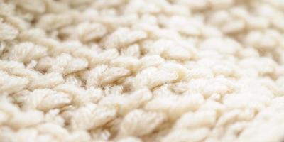 Nahaufnahme beige gestrickter Wollstoff Textur Hintergrund foto