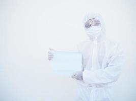 Junger Arzt oder Wissenschaftler in Uniform der PSA-Suite, der mit beiden Händen leeres Papier für Text hält, während er nach vorne schaut. coronavirus oder covid-19 konzept isolierter weißer hintergrund foto