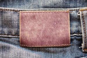 blauer Denim-Jeans-Leder-Label-Textur-Hintergrund foto