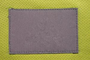 Wäschepflege-Kleidungslabel-Patch auf Polyestergewebe-Jersey-Sportstruktur foto