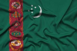 turkmenistan-flagge ist auf einem sportstoff mit vielen falten abgebildet. Sportteam-Banner foto