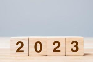 Holzwürfelblock mit 2023-Text auf Tabellenhintergrund. konzepte für auflösung, planung, überprüfung, ziel, start und neujahrsferien foto