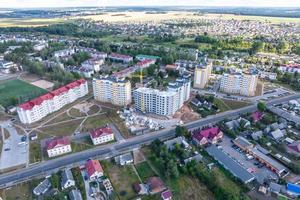 Luftpanorama aus großer Höhe einer kleinen Provinzstadt mit privatem Sektor und Wohnhochhäusern foto