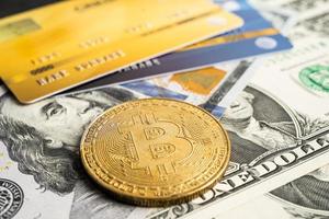 alte bitcoin mit kreditkarte auf us-dollar-banknoten für elektronischen weltweiten austausch von virtuellem geld, blockchain, kryptowährung foto