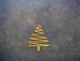 Weihnachtsbaum aus Keksen, auf einem schwarzen Texturhintergrund. foto
