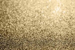 abstraktes goldglitter funkeln verschwommen mit bokeh hintergrund foto