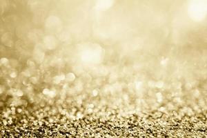 abstraktes goldglitter funkeln verschwommen mit bokeh hintergrund foto