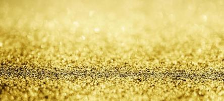 abstraktes goldglitter funkeln mit bokeh hintergrund foto