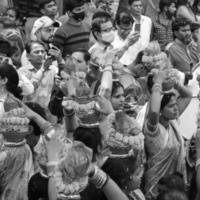 delhi, indien 03. april 2022 - frauen mit kalash auf dem kopf während des jagannath-tempels mangal kalash yatra, indische hindu-anhänger tragen irdene töpfe mit heiligem wasser mit kokosnuss auf der oberseite - schwarz und weiß foto