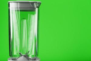 Ein weißer Mixer mit einem leeren Glas auf grünem Hintergrund. foto
