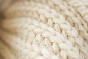 Closeup beige gestrickter Wollstoff Hintergrund foto