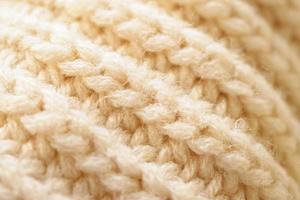 Nahaufnahme beige gestrickter Wollstoff Textur Hintergrund foto