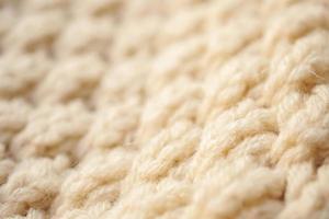 Nahaufnahme beige gestrickter Wollstoff Textur Hintergrund foto